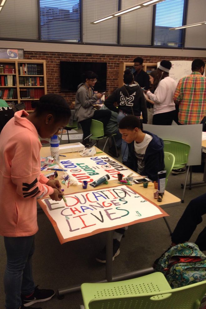 Photograph of Baltimore School for the Arts students making signs for a rally