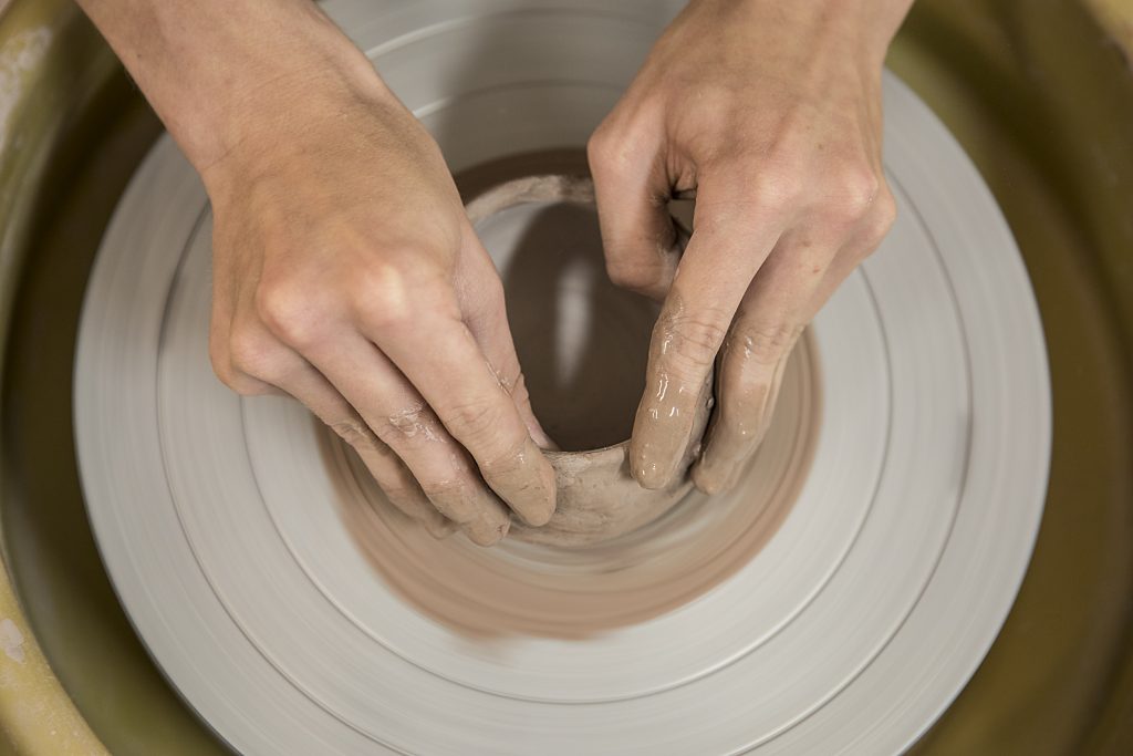 Photograph of Baltimore School for the Arts student working on a pottery project